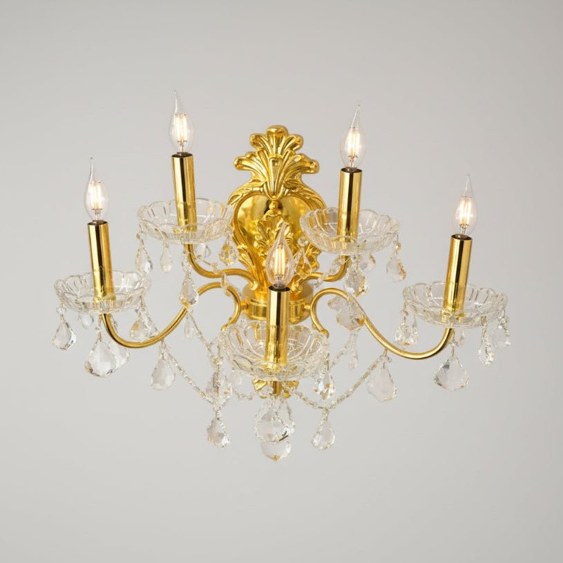 gold victorian sconce with clear crystal on gray background